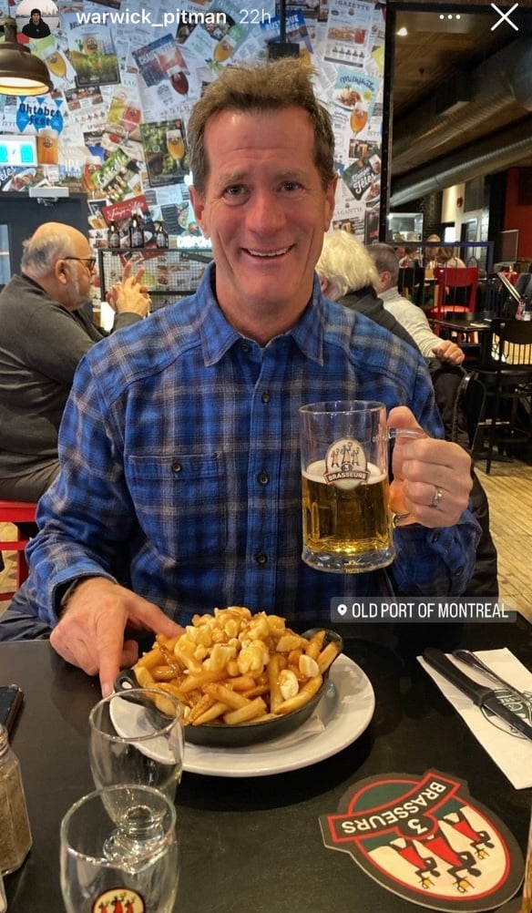 dad trying poutine in Old Port while visiting his son studying in Montreal